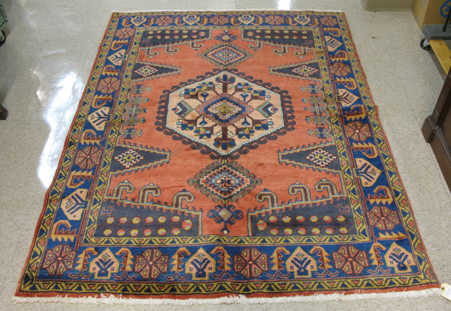 Appraisal: PERSIAN TRIBAL AREA RUG geometric pattern on red rose ground