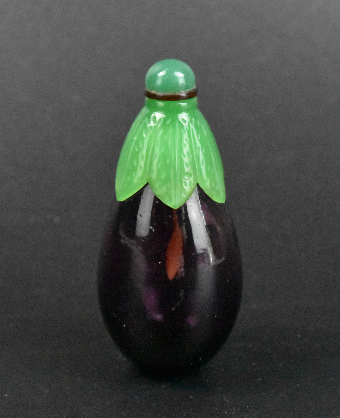 Appraisal: A Chinese glass carved aubergine snuff bottle dating from the