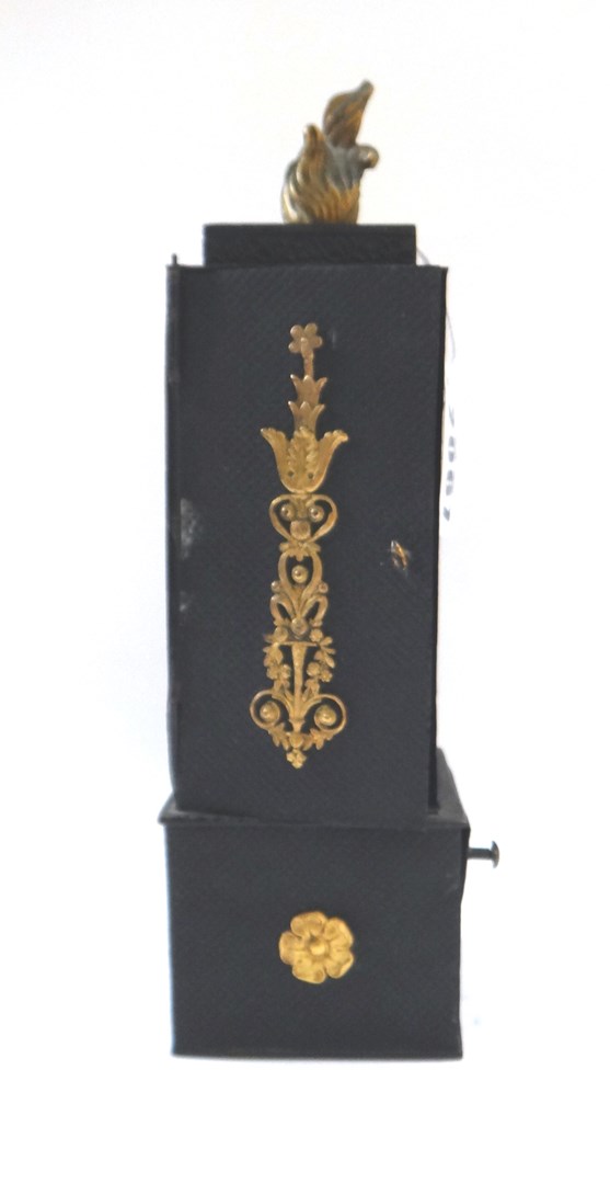 Appraisal: An unusual ebonised metal and ormolu mounted portable candle holder