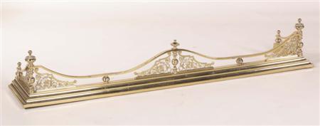 Appraisal: A Regency style brass fender the serpentine top-rail mounted with