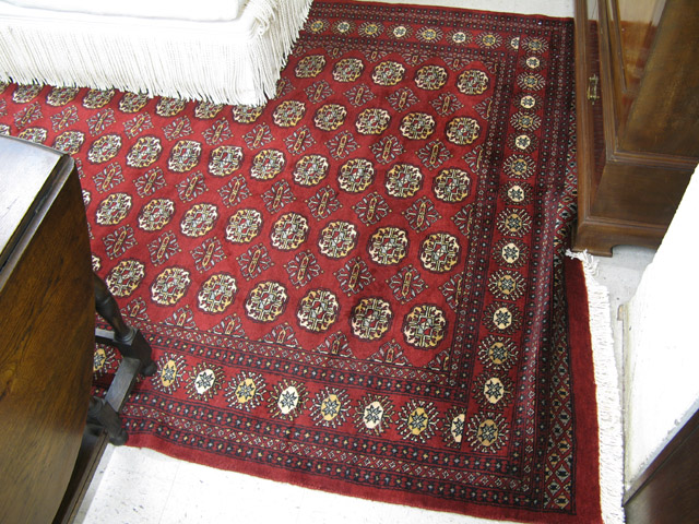 Appraisal: PAKISTANI BOKHARA CARPET repeating columns of geometric Turkoman gols on