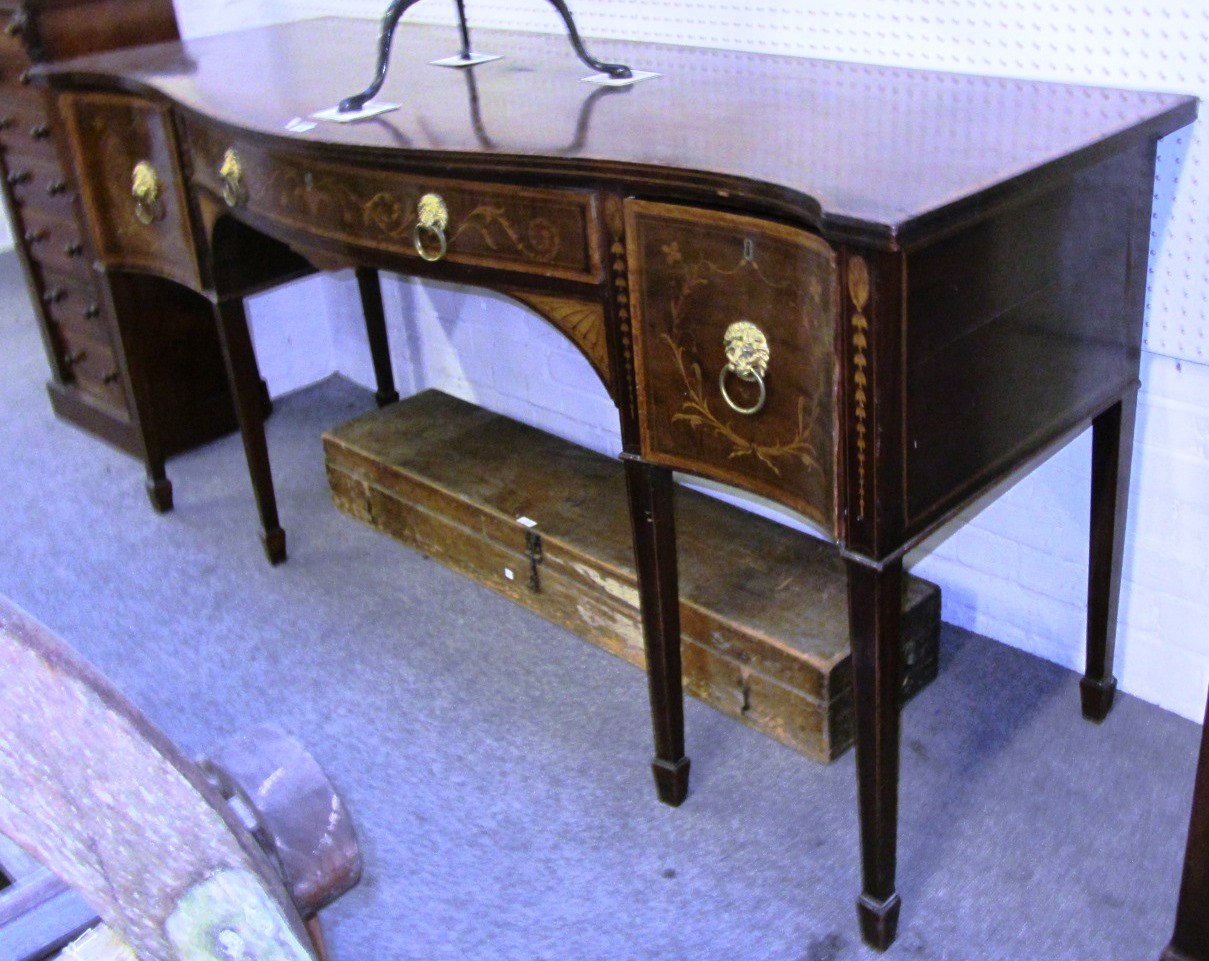 Appraisal: A marquetry inlaid George III mahogany serpentine sideboard with three