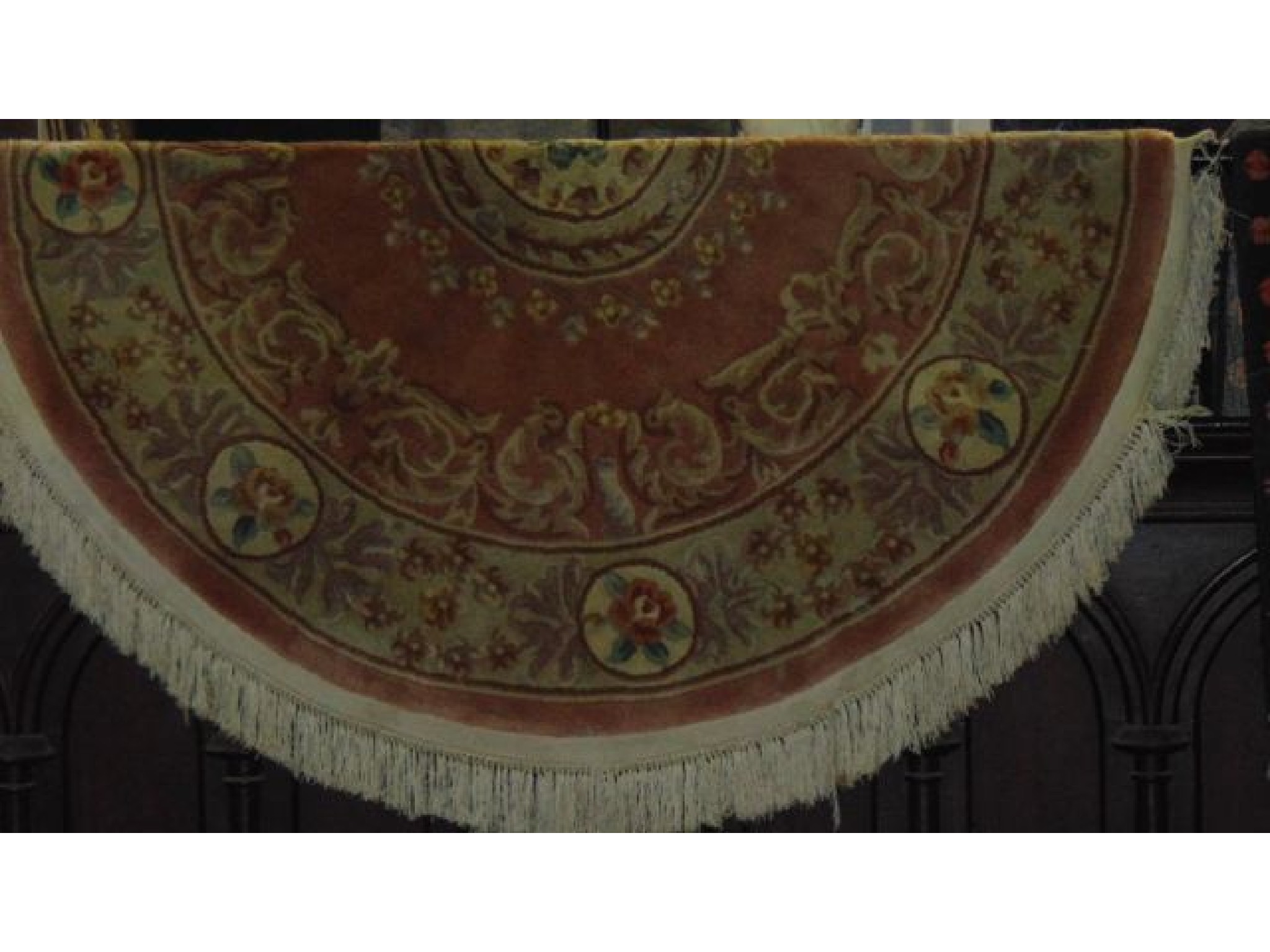 Appraisal: An oval Chinese rug in pastel shades with floral detail