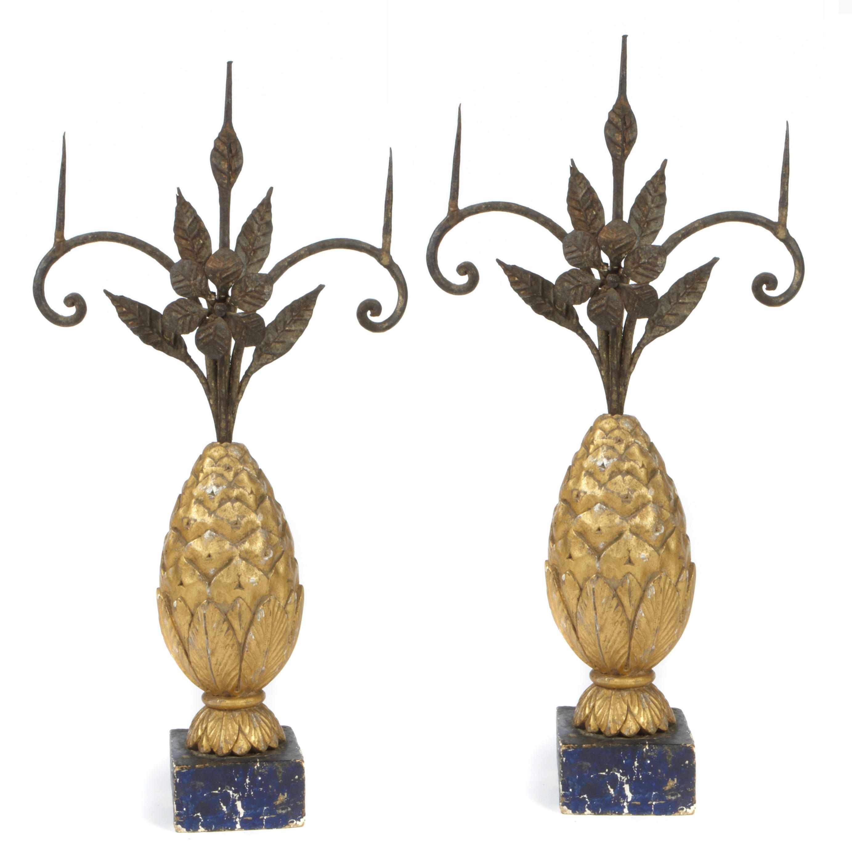 Appraisal: A pair of carved polychrome decorated wood and wrought iron