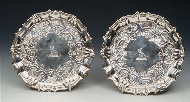 Appraisal: A MATCHED PAIR OF GEORGE II SALVERS with shaped sides