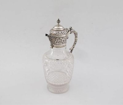 Appraisal: An Edwardian mounted cut-glass claret jug with an embossed mount