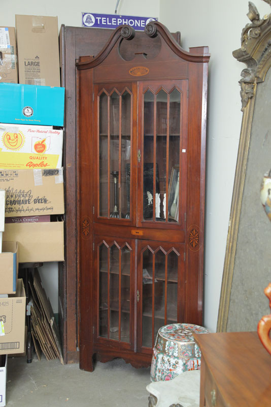 Appraisal: CORNER CUPBOARD Mahogany having a broken arch pediment glazed doors