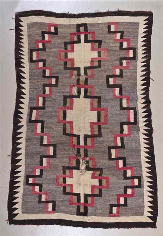 Appraisal: A Navajo Wool Rug having repeating geometric decoration in tones