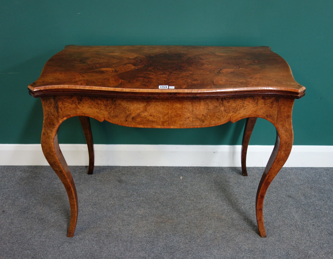 Appraisal: A mid Victorian figured walnut card table with serpentine top