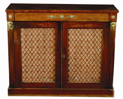 Appraisal: An Empire style mahogany chiffonier with brass mounts and grille