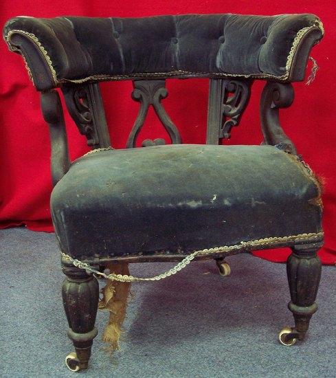 Appraisal: A Victorian elbow chair the buttoned back above carved scrolling