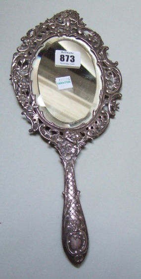 Appraisal: A silver shaped oval hand mirror the border with floral