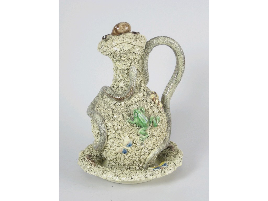 Appraisal: A Palissy style lidded Jug on Stand decorated snake lizard