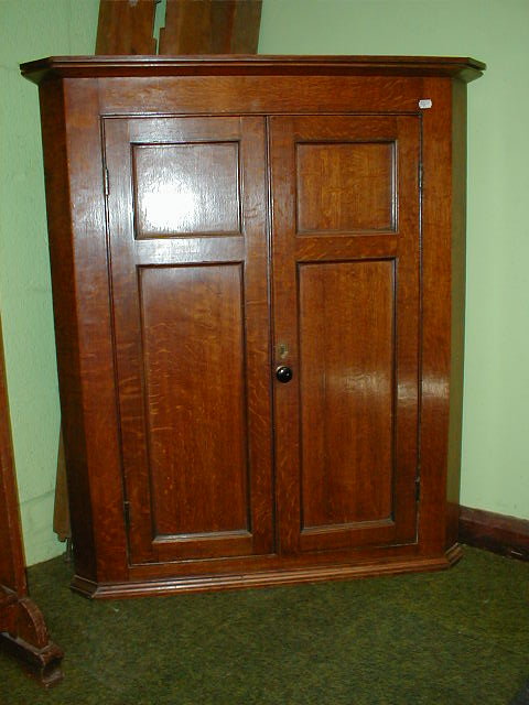 Appraisal: A George III oak hanging corner cupboard high -