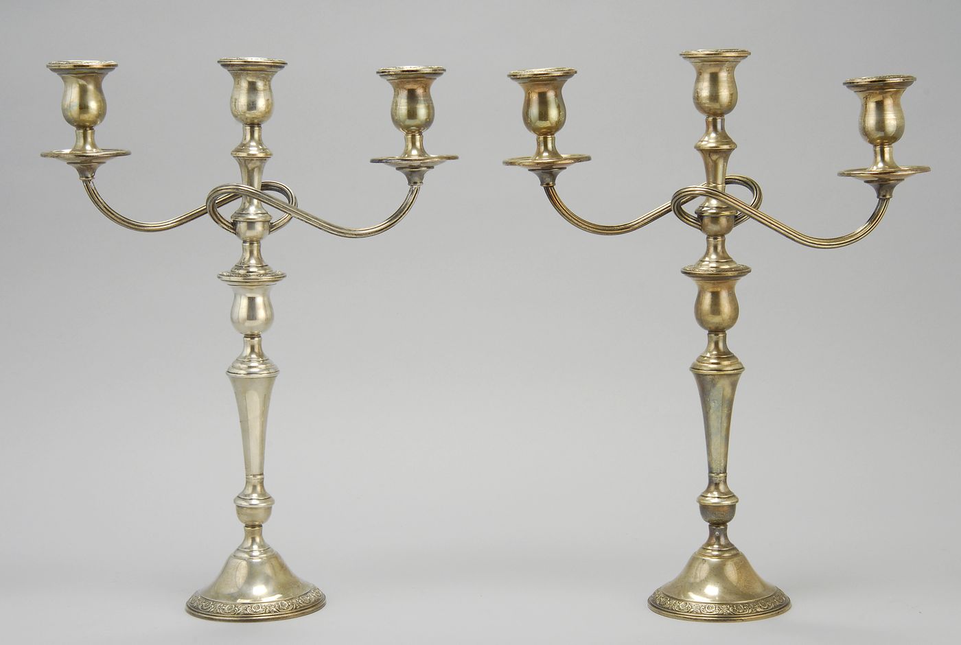 Appraisal: PAIR OF STERLING SILVER WEIGHTED THREE-SOCLE CANDELABRA By International Silver