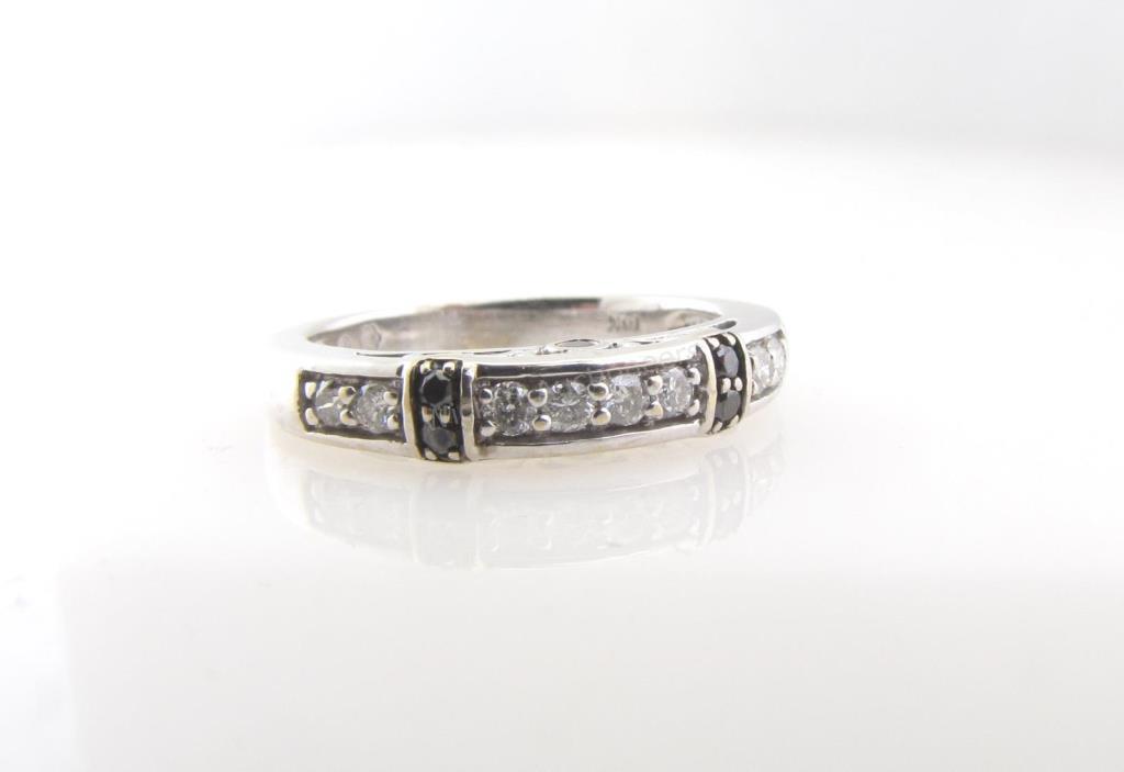 Appraisal: A K white gold band ring containing eight round brilliant