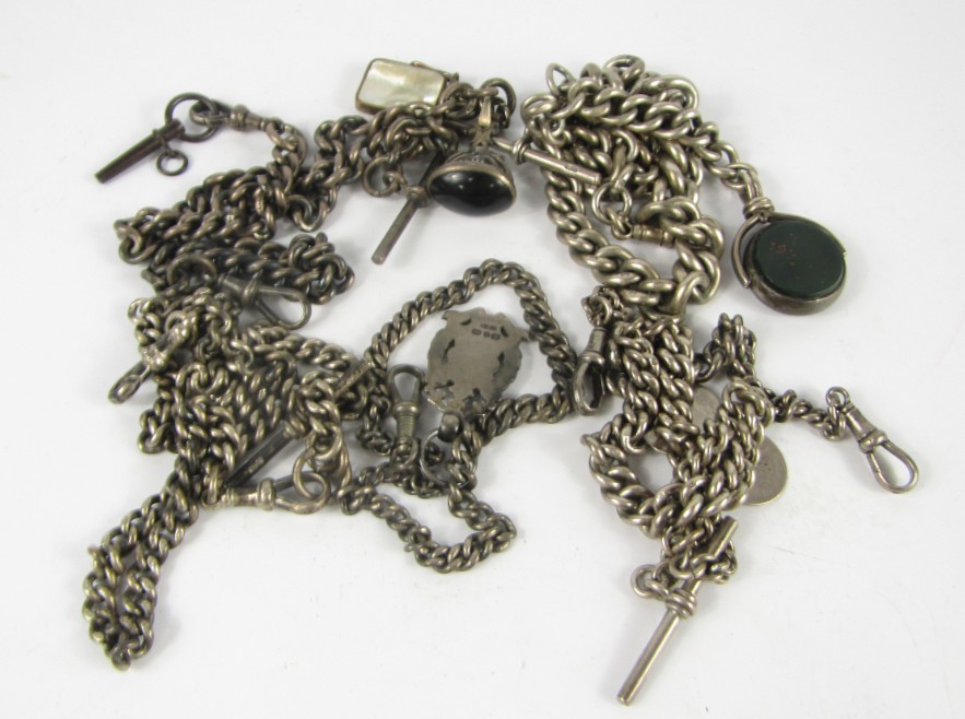 Appraisal: Five silver curb link Albert chains four with attachments comprising