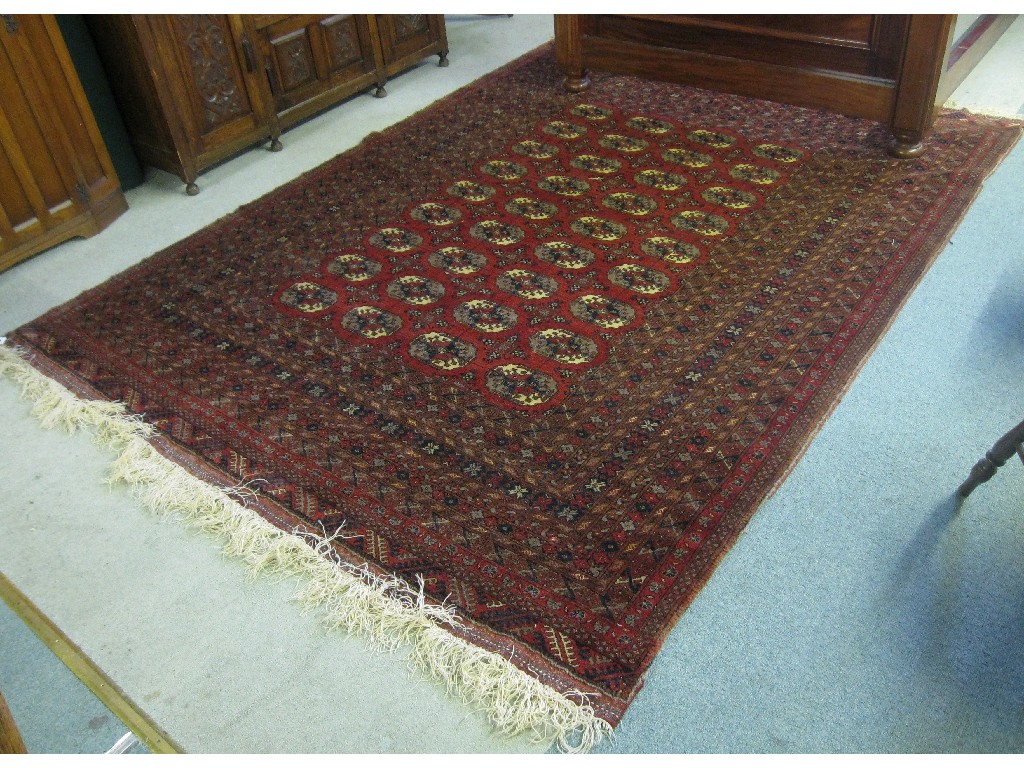 Appraisal: Eastern rug with red ground and central full decorated panel