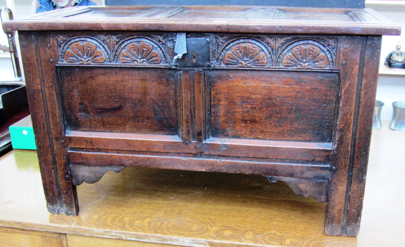 Appraisal: A th century oak coffer with triple panel lid over