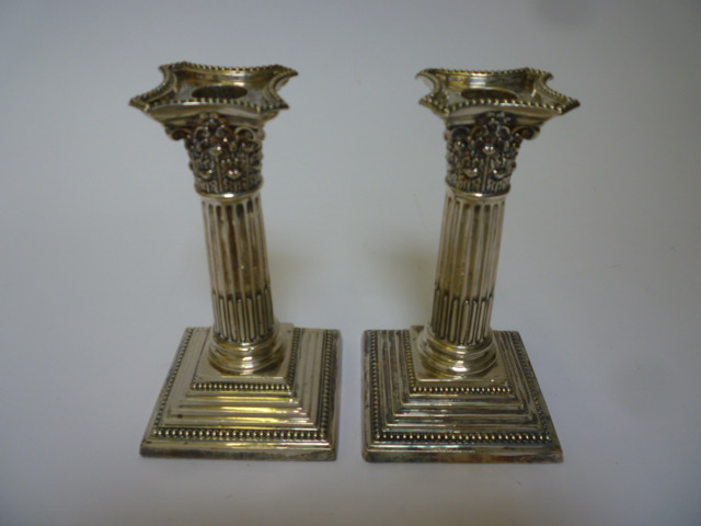 Appraisal: A PAIR OF LATE VICTORIAN CORINTHIAN COLUMN CANDLESTICKS maker's mark