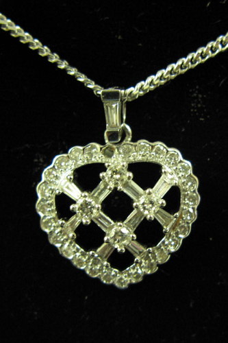 Appraisal: DIAMOND AND FOURTEEN KARAT WHITE GOLD HEART PENDANT NECKLACE The