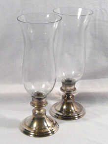 Appraisal: A pair of silver plated storm lamps with glass shades