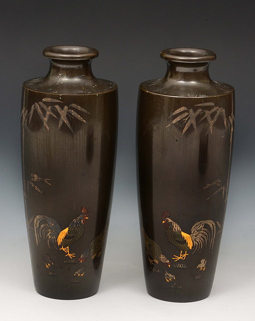 Appraisal: A pair of Japanese bronze vasesMeiji periodsigned Kurumi inlaid in