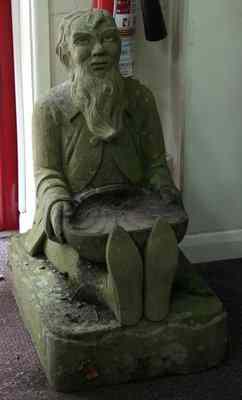 Appraisal: A stone carving of a seated gnome