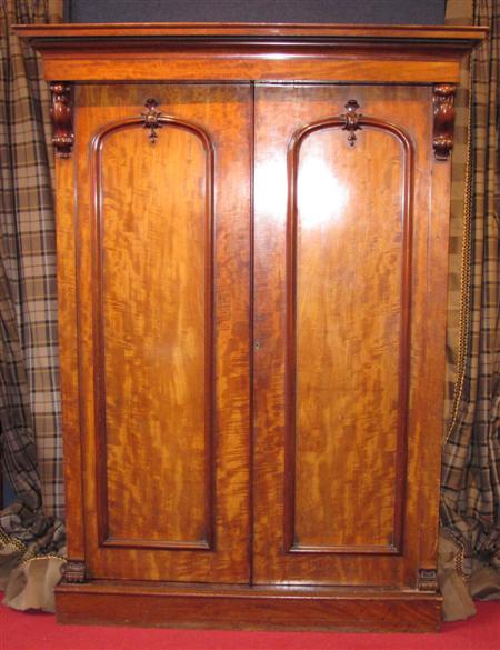 Appraisal: A Victorian mahogany two door wardrobe the projected moulded cornice