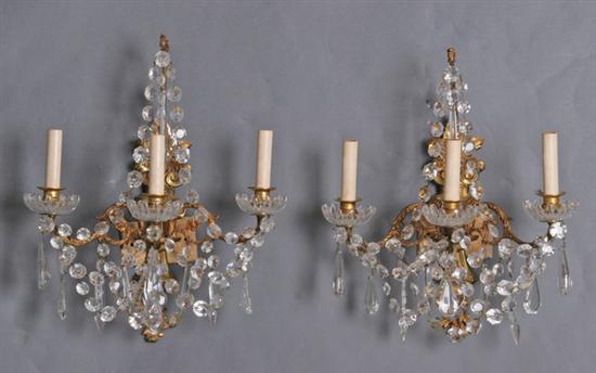 Appraisal: PAIR GILT-METAL THREE-LIGHT SCONCES th century Shaped backplate issuing three