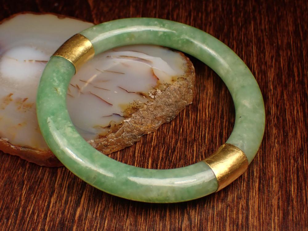 Appraisal: GREEN JADE AND TWENTY-TWO KARAT GOLD BANGLE The round green