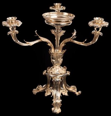 Appraisal: A silver plated epergne the central circular bowl flanked by