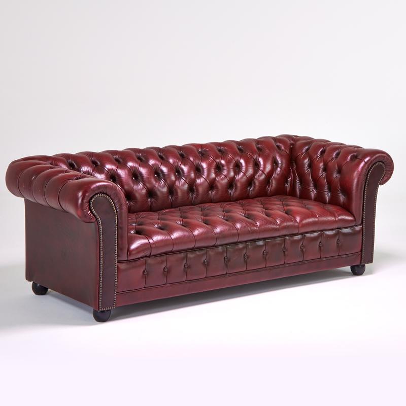 Appraisal: CHESTERFIELD Sofa USA s Burgundy leather brass studs stained wood