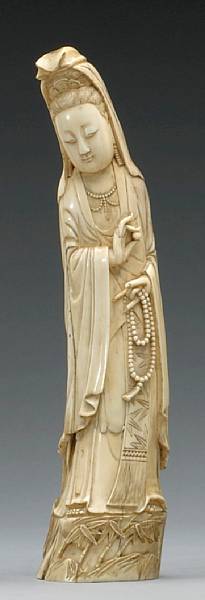 Appraisal: A tinted ivory figure of Guanyin th Century The veiled