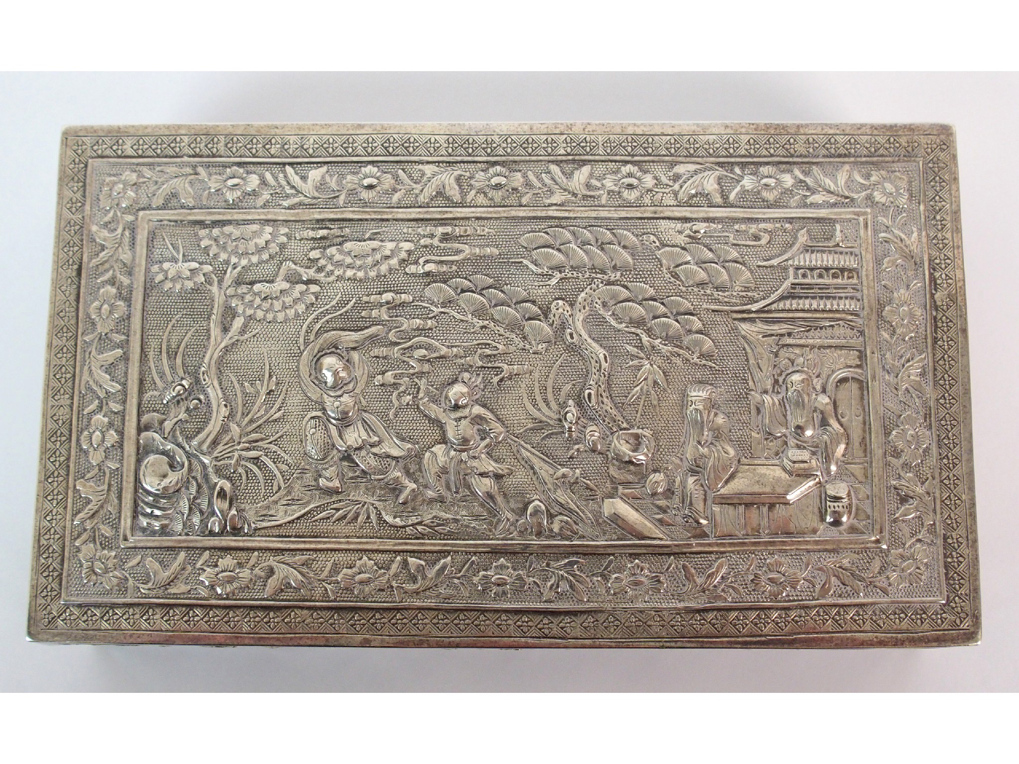 Appraisal: A Chinese silver rectangular boxdecorated allover with figures in gardens