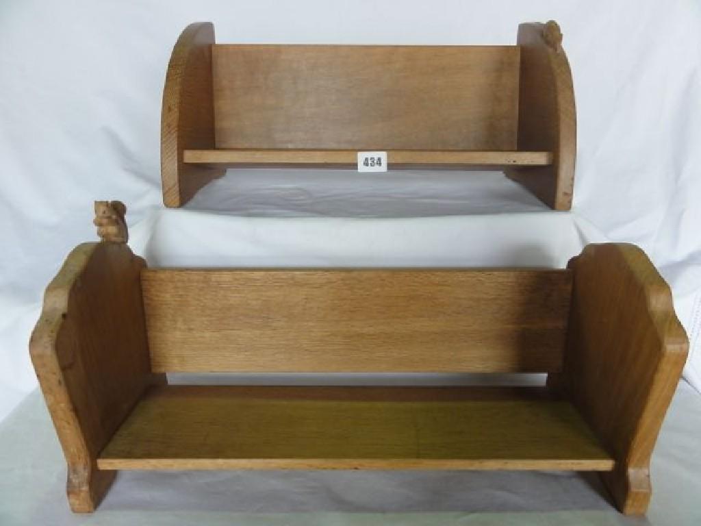 Appraisal: A Mouseman oak book trough with D-end supports together with