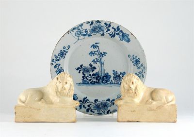 Appraisal: A pair of creamware models of lions recumbent on rectangular