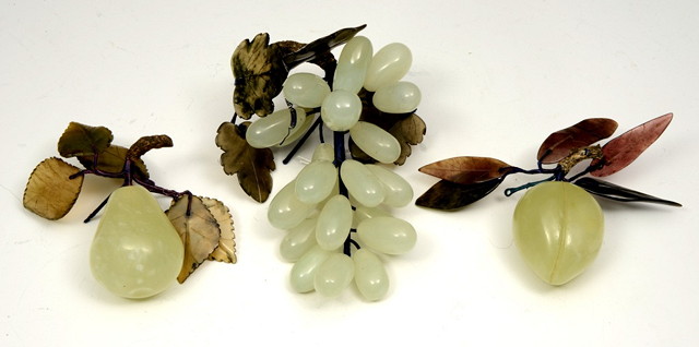 Appraisal: A GROUP OF THREE ORIENTAL GREEN HARDSTONE FRUIT ORNAMENTS with