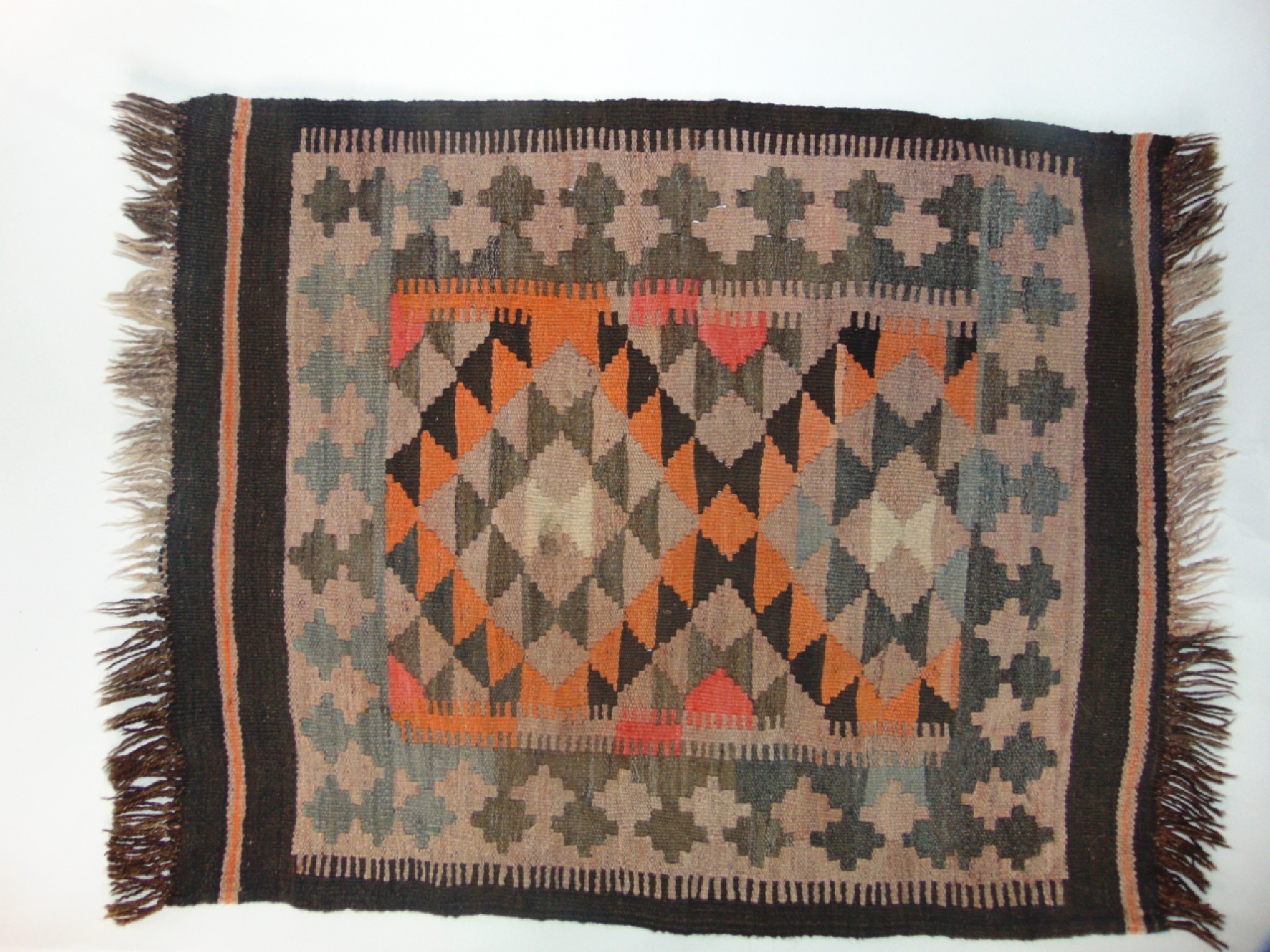 Appraisal: A small Kelim type woven wool rug decorated with triangular