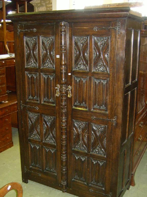 Appraisal: A late th century oak wardrobe enclosed by two doors