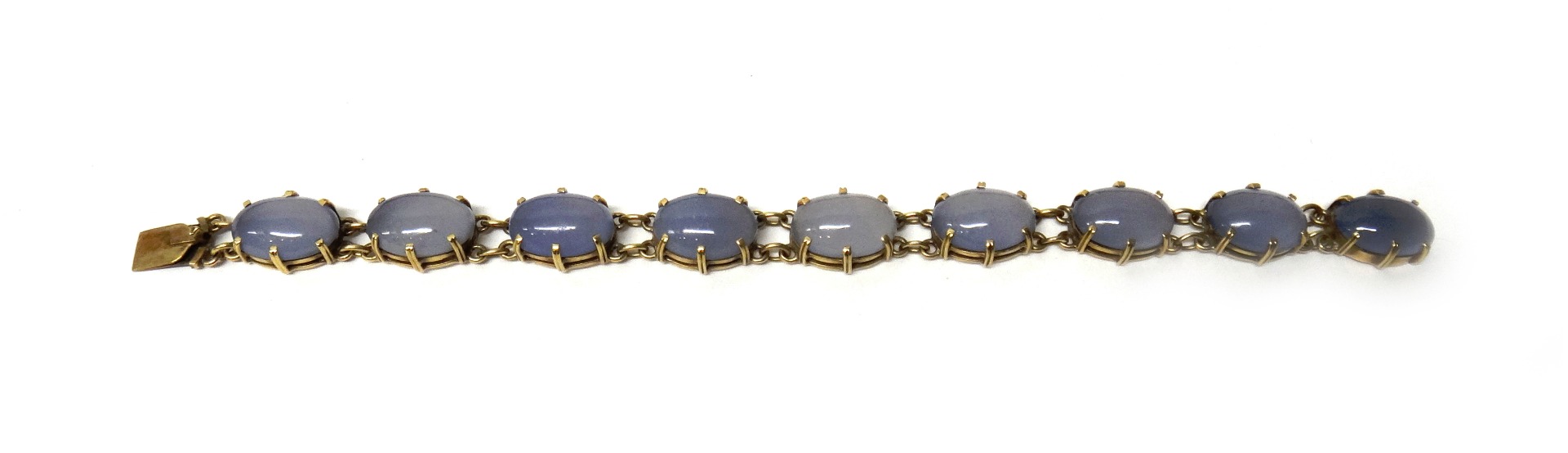 Appraisal: A gold mounted dyed pale blue agate set brooch designed