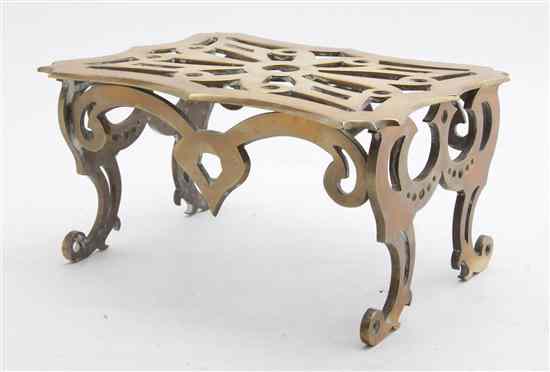 Appraisal: An English Brass Trivet having a pierced and shaped rectangular