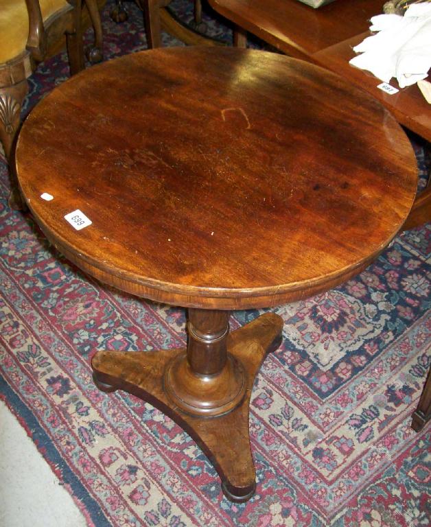 Appraisal: A Victorian circular mahogany occasional table on central turned column