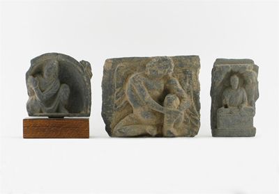 Appraisal: Three Gandh ra grey schist carvings of seated figures one