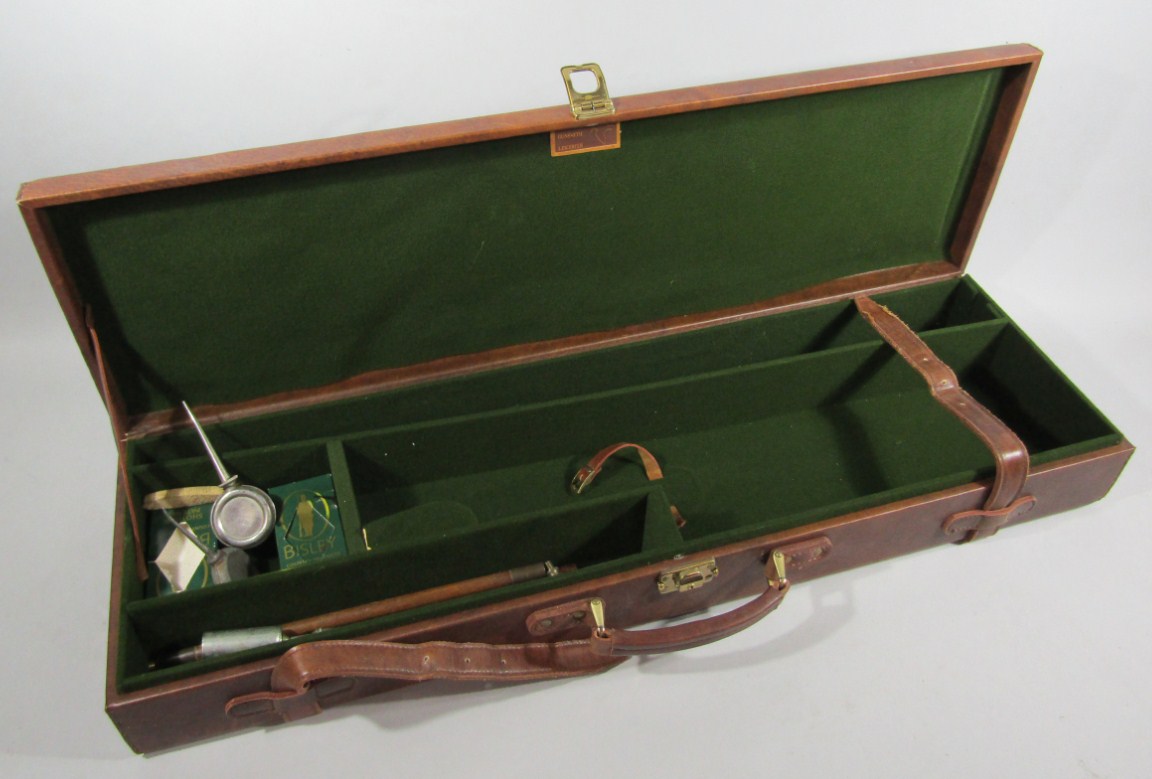 Appraisal: A leather finish shotgun case with two bore cleaning outfits