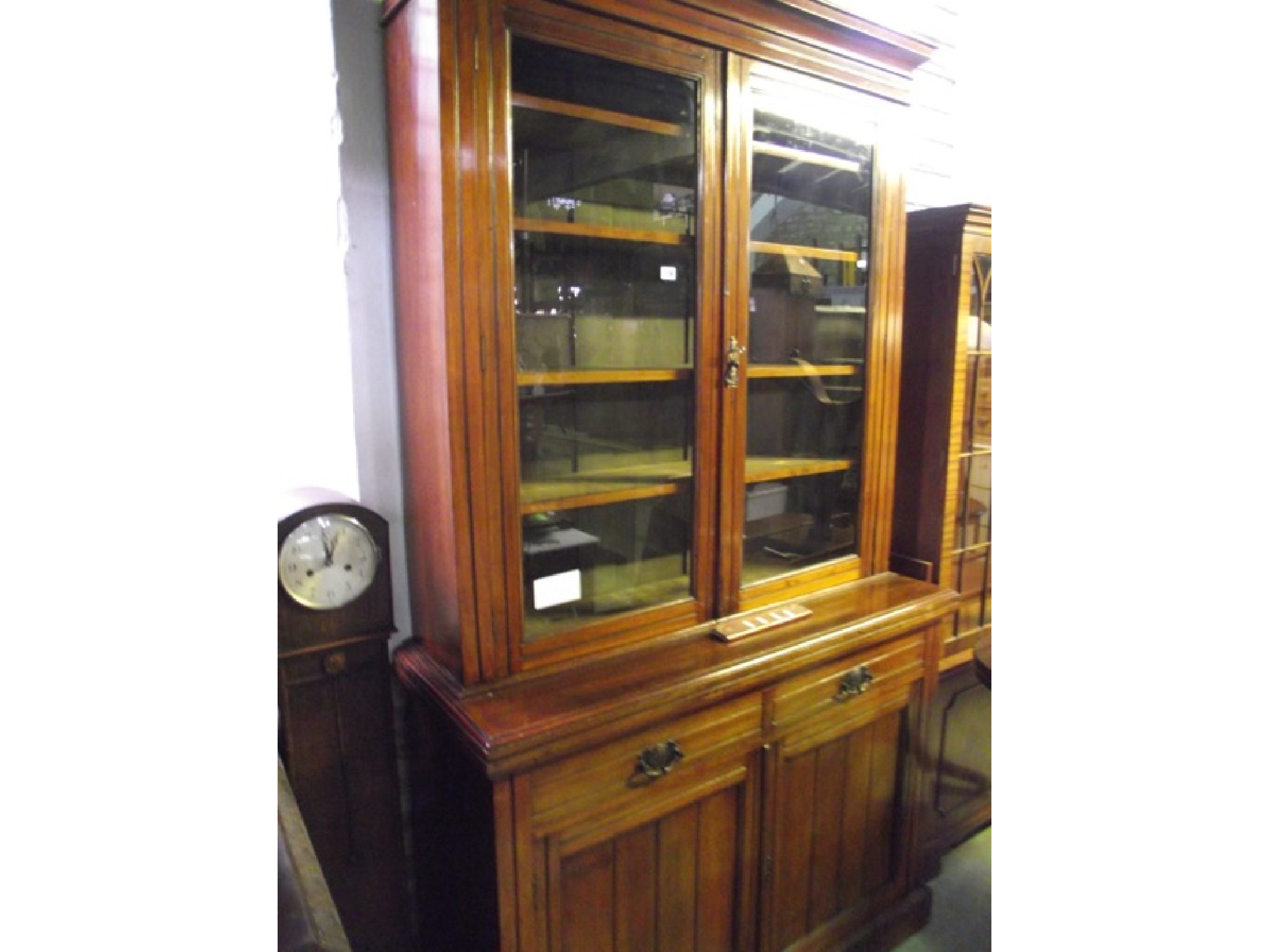 Appraisal: An Edwardian walnut library bookcase the upper recesssed section with