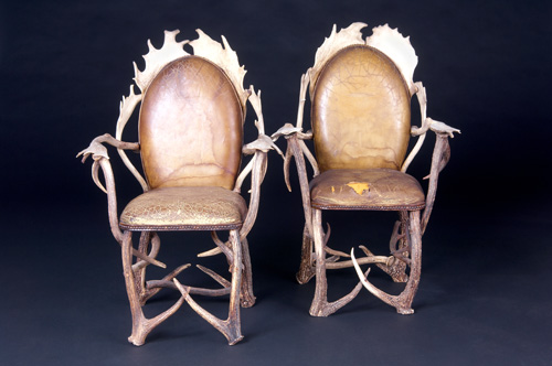 Appraisal: AMERICAN STUDIO Pair of antler armchairs with original tacked-on leather