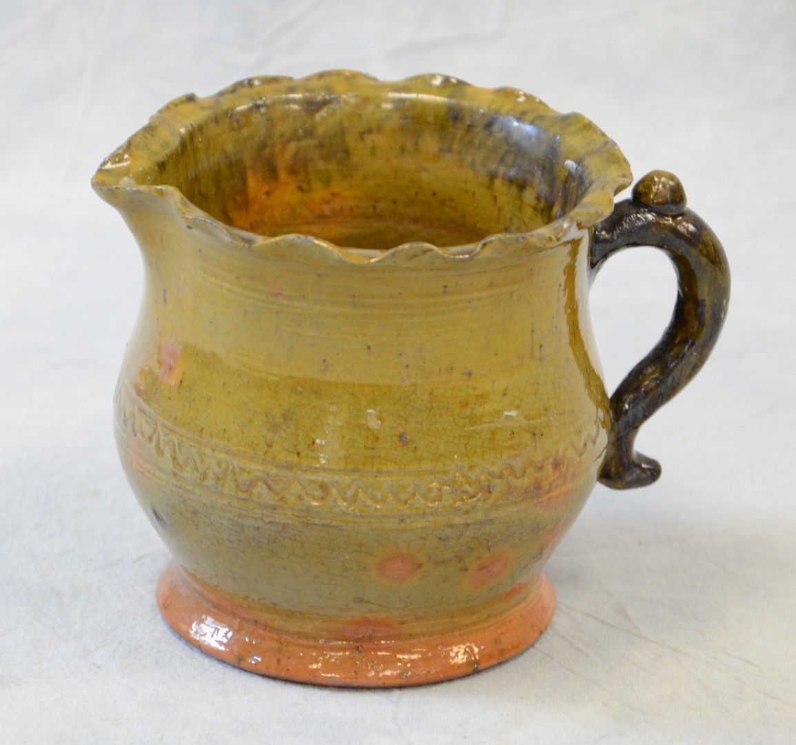 Appraisal: IS Stahl Pottery creamer dated August green glaze with orange