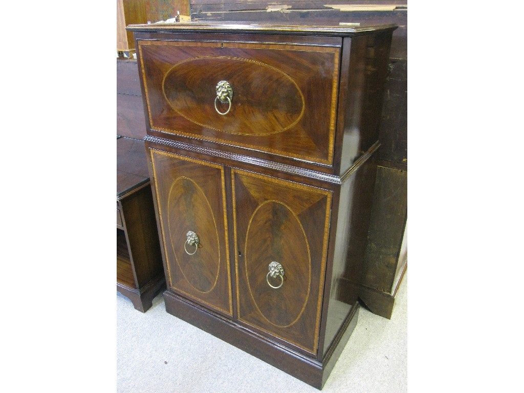 Appraisal: Mahogany and crossbanded drinks cabinet with fitted interior and lion's