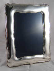 Appraisal: A large silver photo frame with strut back Birmingham millennium